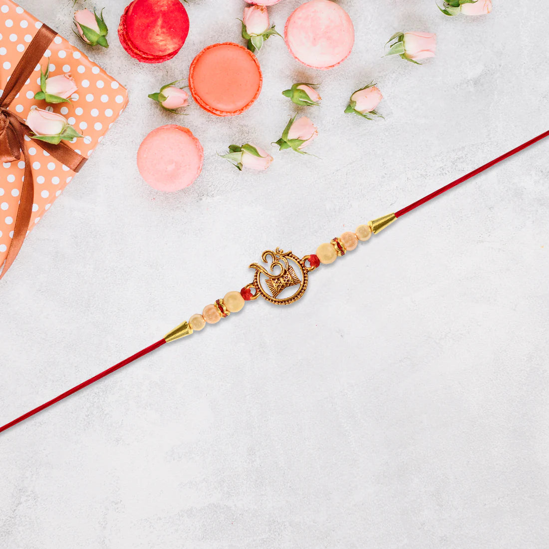 Om Swastik Rakhi – Golden Motif with Pearl Beads for Brother
