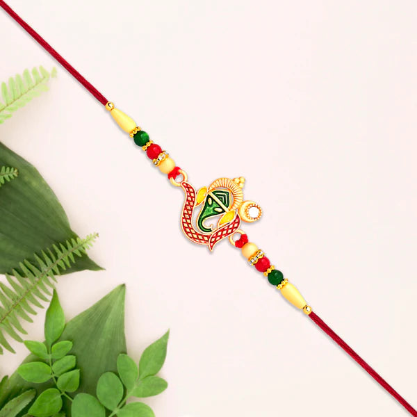 Top-down view of the decorative Ganesha Rakhi with vibrant threads and beads.