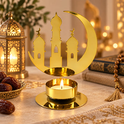 A golden metal crescent moon and mosque design incense holder with a lit tealight candle.