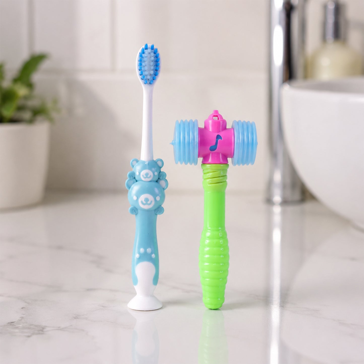 Kids' manual toothbrush and hammer toy on a white surface