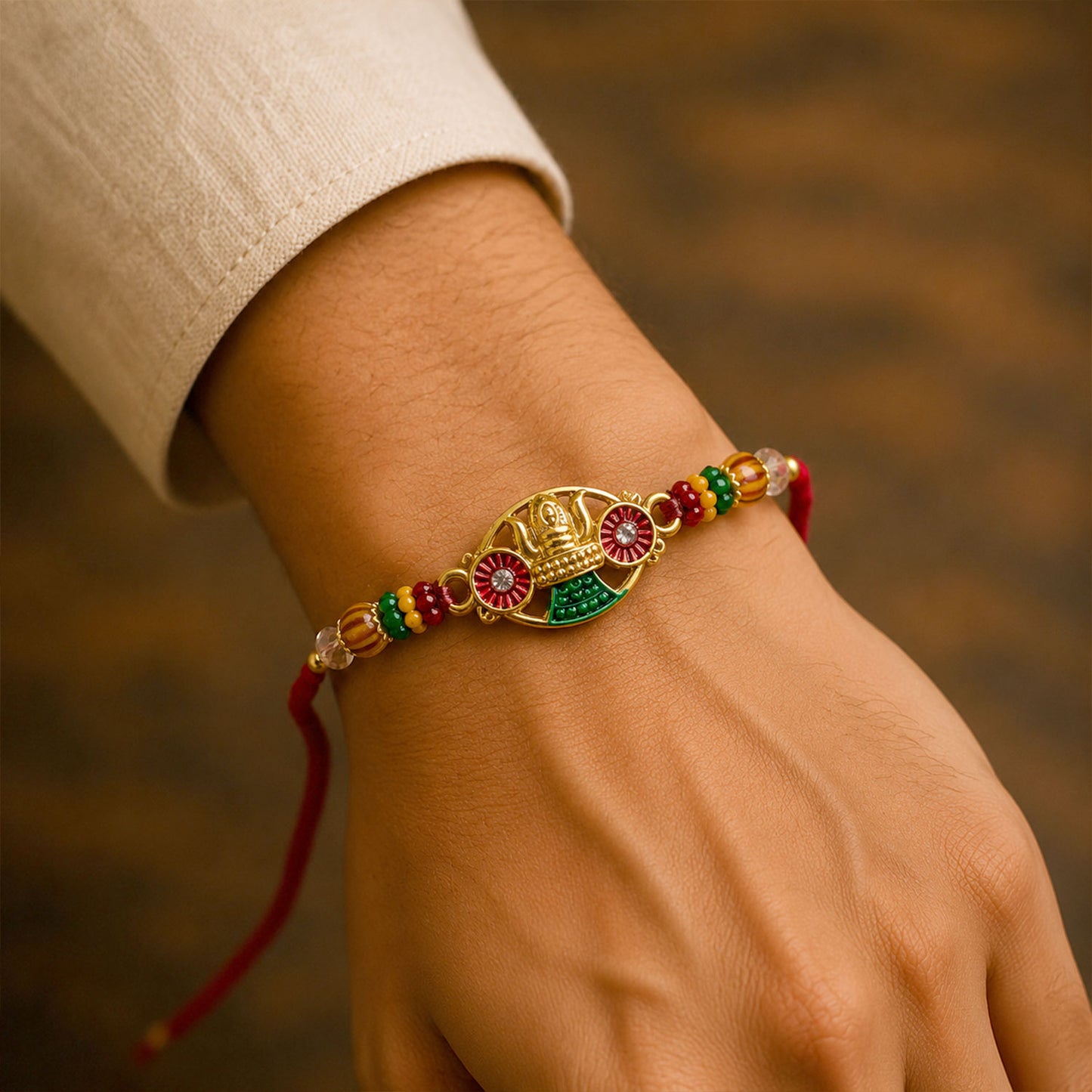 Golden Kalash Temple Devotional Rakhi with Red Green Details and Festive Beads