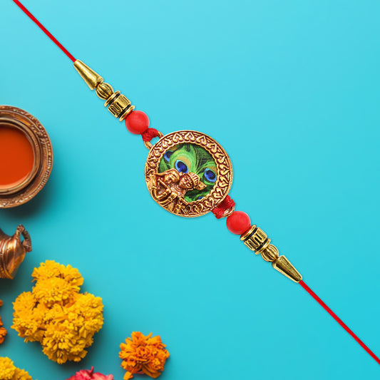 Traditional Krishna Rakhi with Peacock Feather Design and Decorative Beads on Red Thread