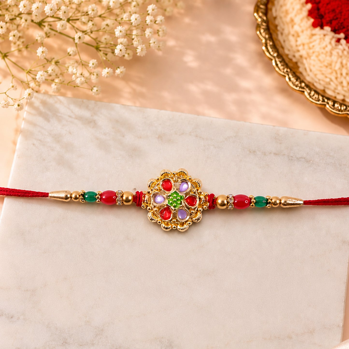 Red and Lilac Kundan Pendant Rakhi with Green Flower Centre