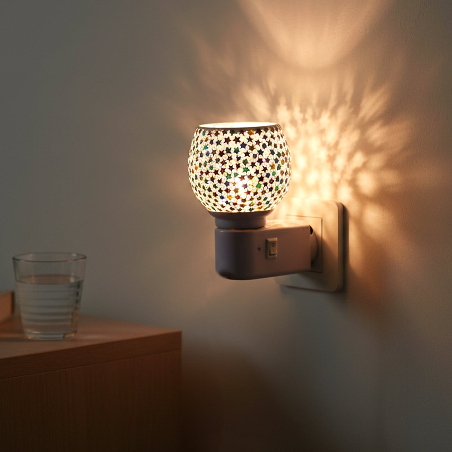 Close-up of star pattern mosaic glass shade on night lamp