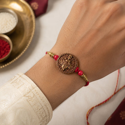 Ganesha Coin Rakhi – Antique Design with Red Beads