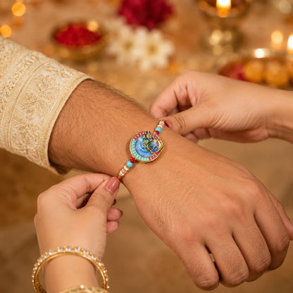 Designer Rakhi featuring peacock motif and decorative beads