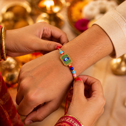 Top angle of mint green thread Evil Eye Rakhi