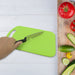 Set of plastic chopping board and steel knife for kitchen tasks