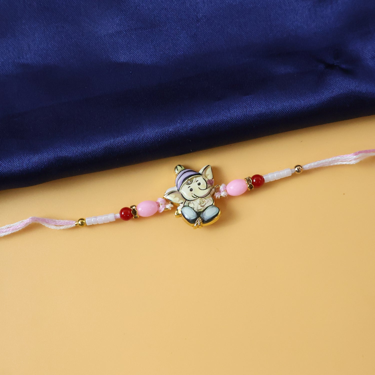 Cute Ganesha Designer Rakhi with Pink and Red Beads (1 Pc)