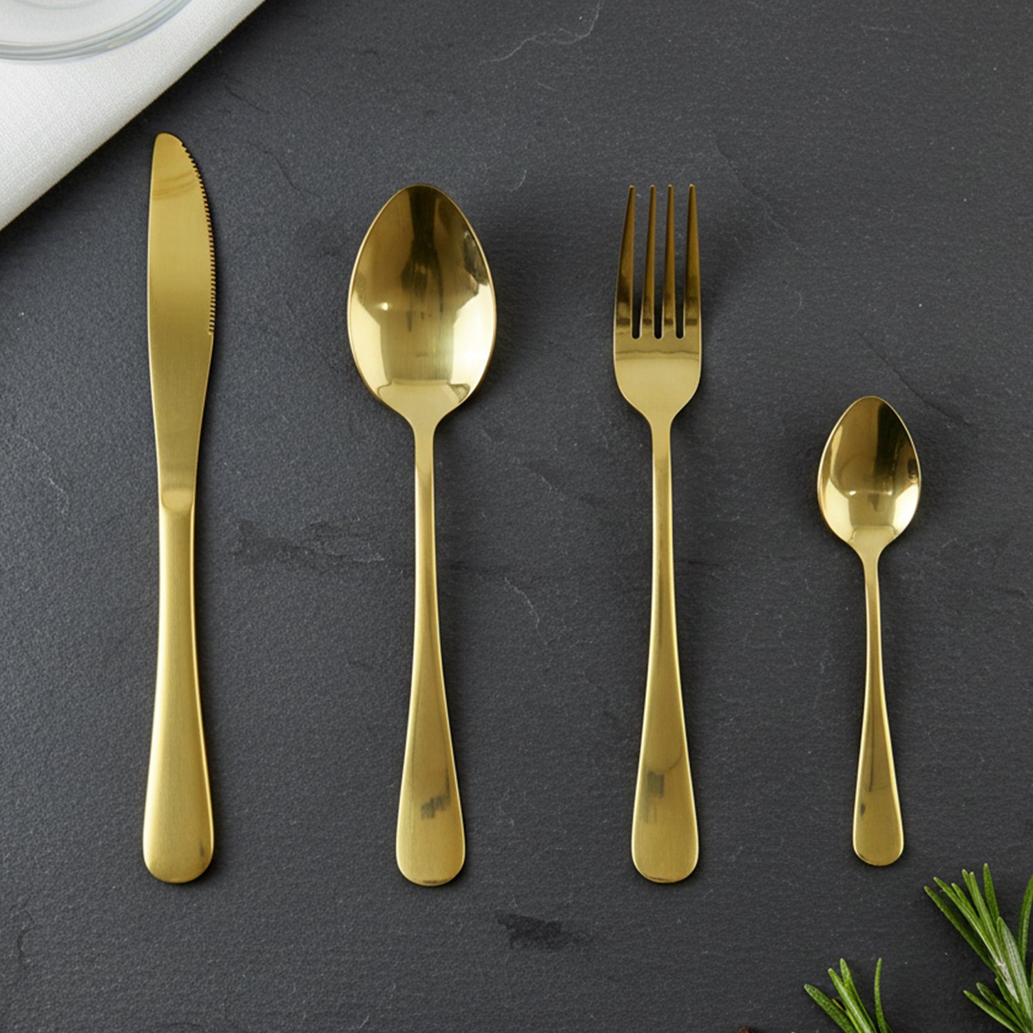 Gold cutlery pieces laid out