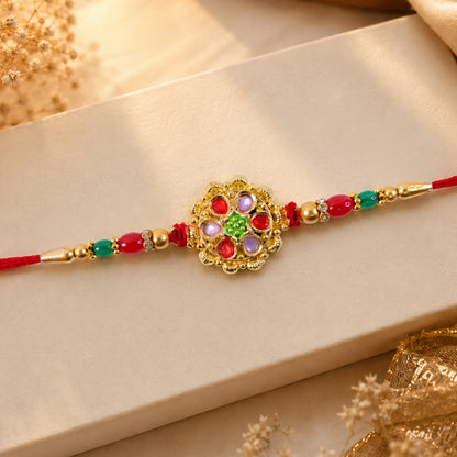 Red and Lilac Kundan Pendant Rakhi with Green Flower Centre