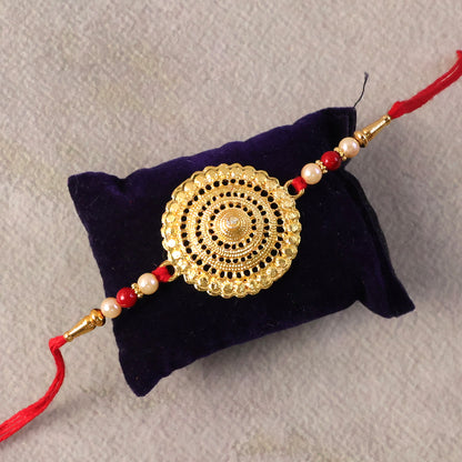 Elegant Rakhi showcasing gold centerpiece and pearl beads