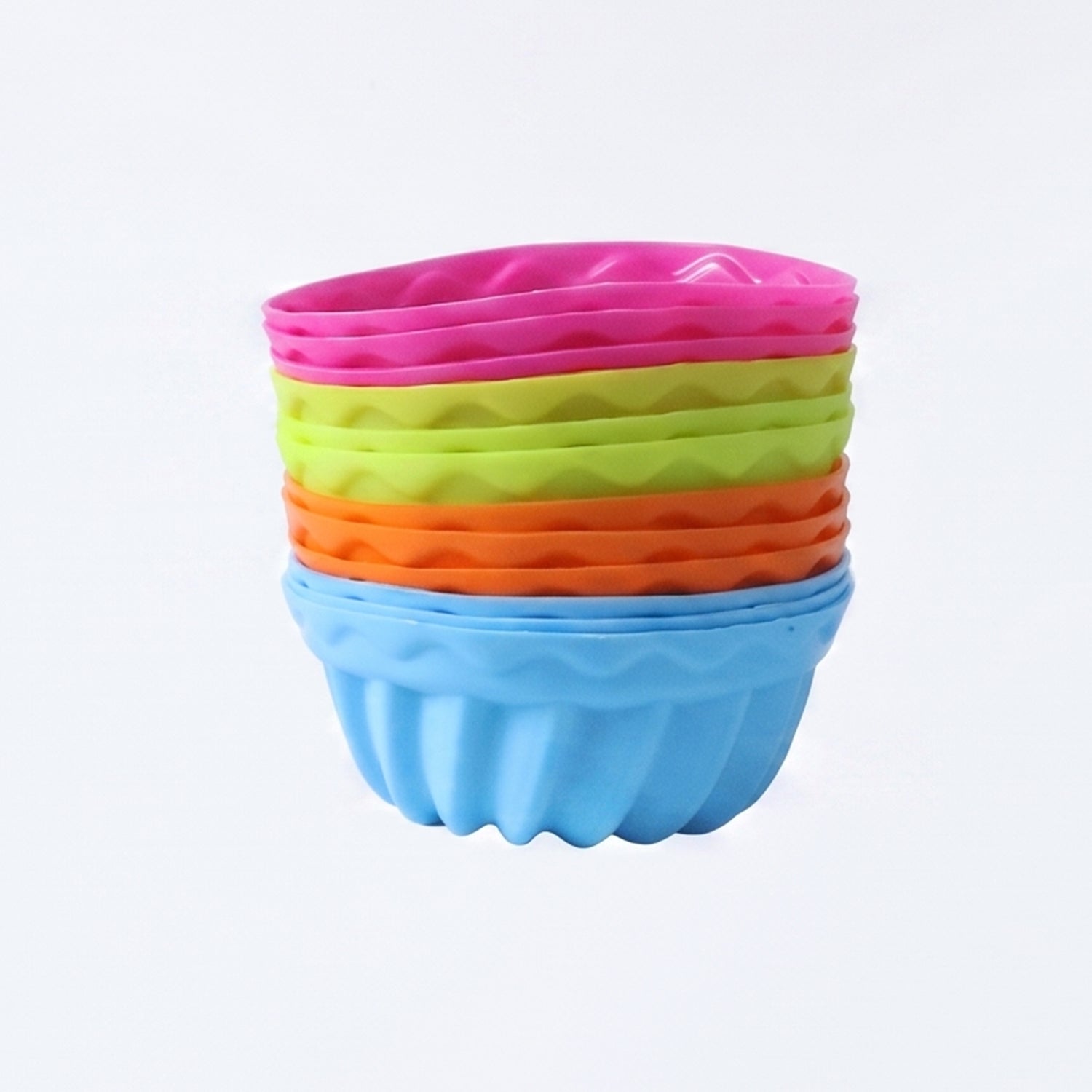 Stack of silicone cupcake cups on white background