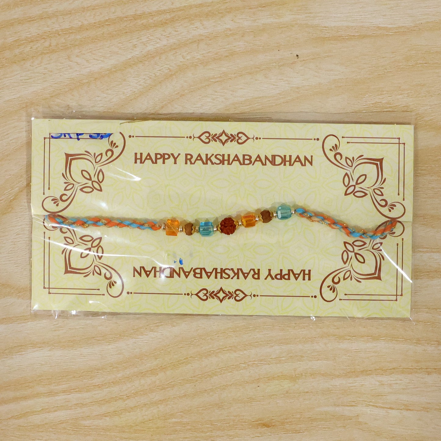 Blue Beaded Bracelet Rakhi with Golden Spacers and Colorful Festive Charm