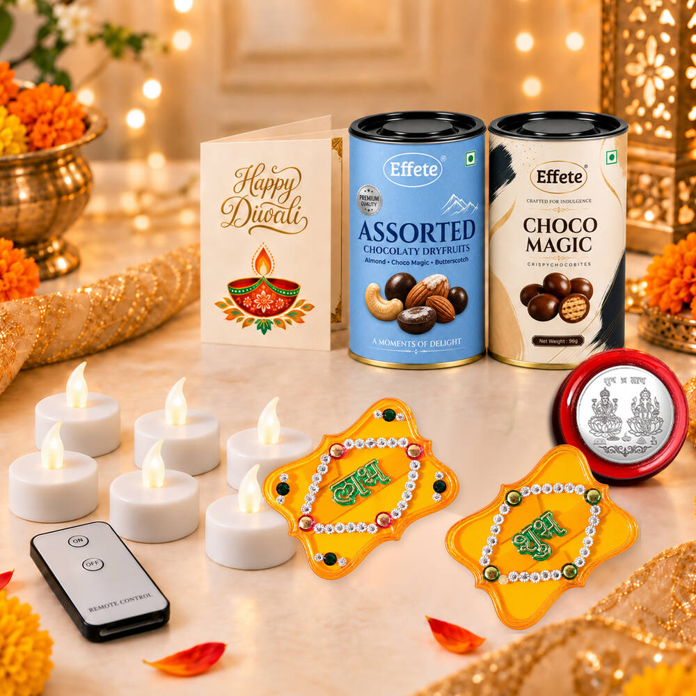 A festive arrangement of Diwali items including two chocolate tins, a greeting card, six LED candles, a remote control, and