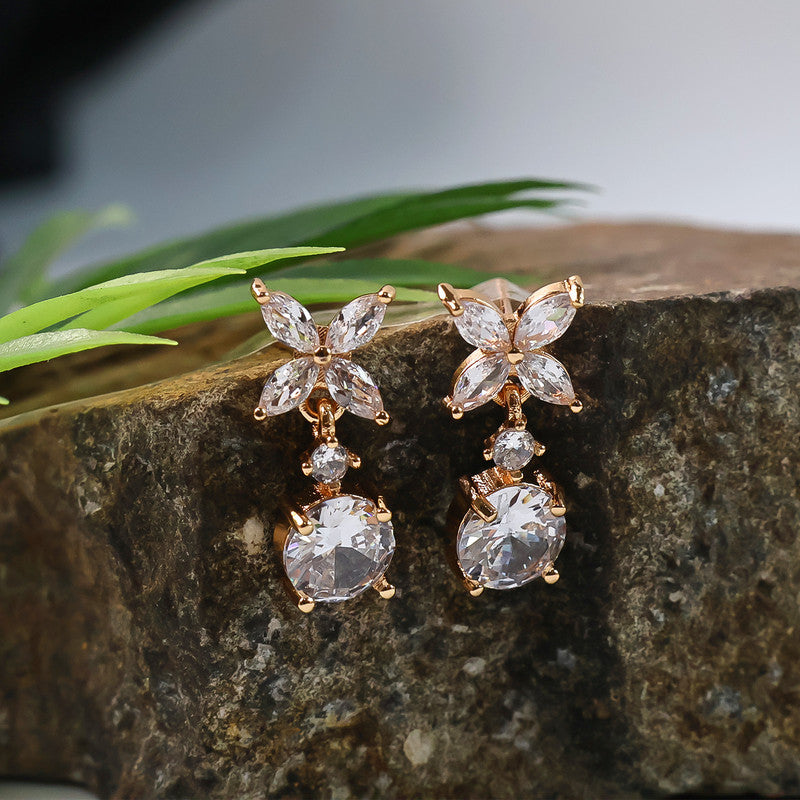Close-up of gold plated floral CZ diamond drop earrings detailing