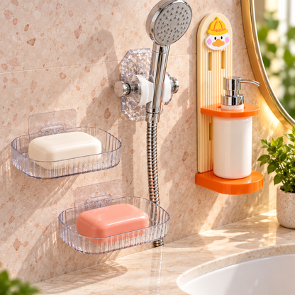Two clear plastic soap dishes hold white and pink soap bars on a tiled bathroom wall.