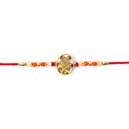 Hand holding peacock design rakhi with bright beads