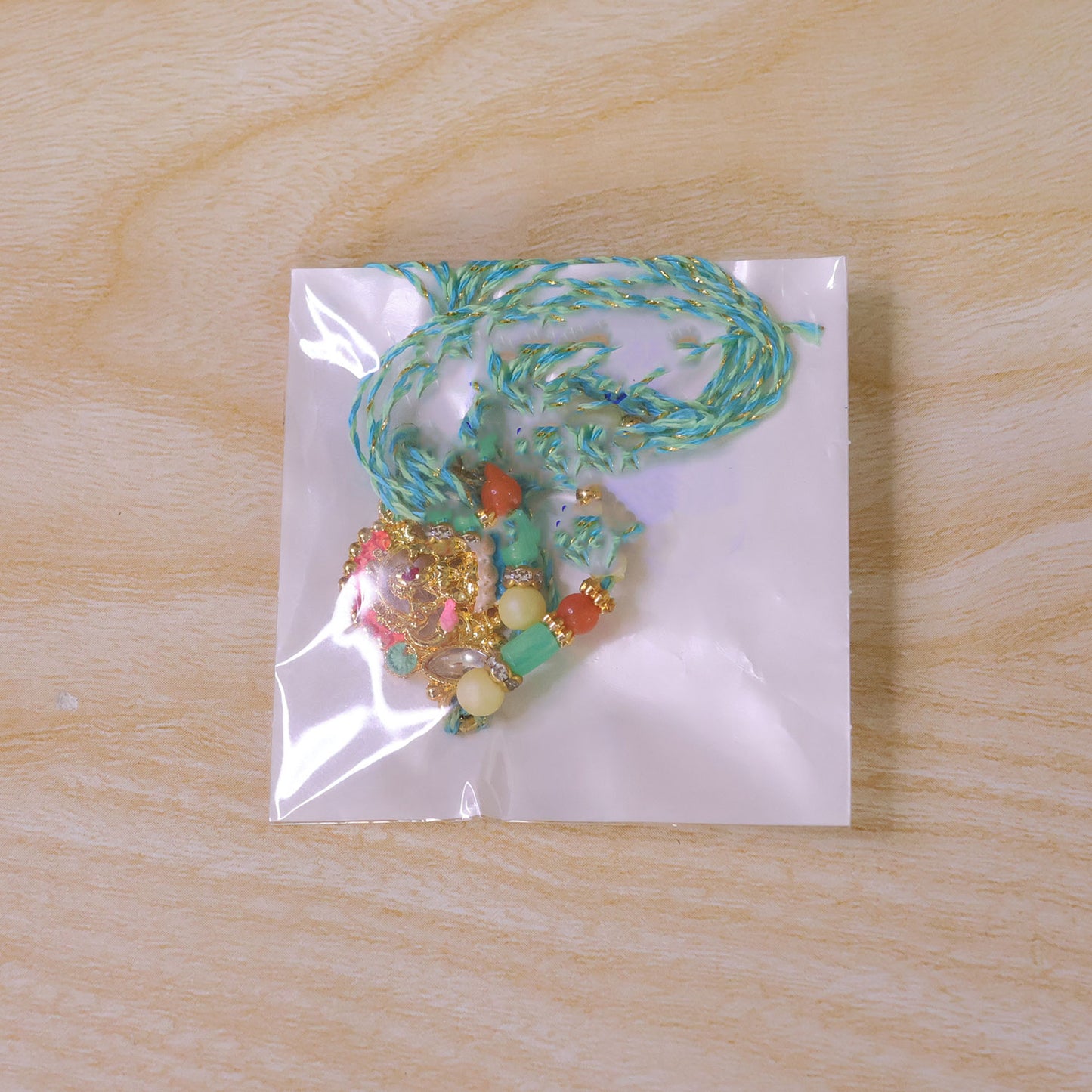 Orange Enamel Floral Kundan Pendant Rakhi with Pastel Beads
