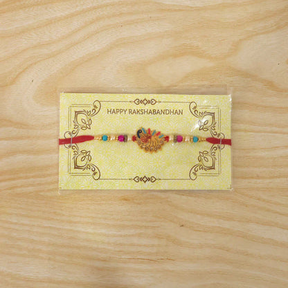 Peacock Rakhi – Colourful Stone Detailing & Red Thread