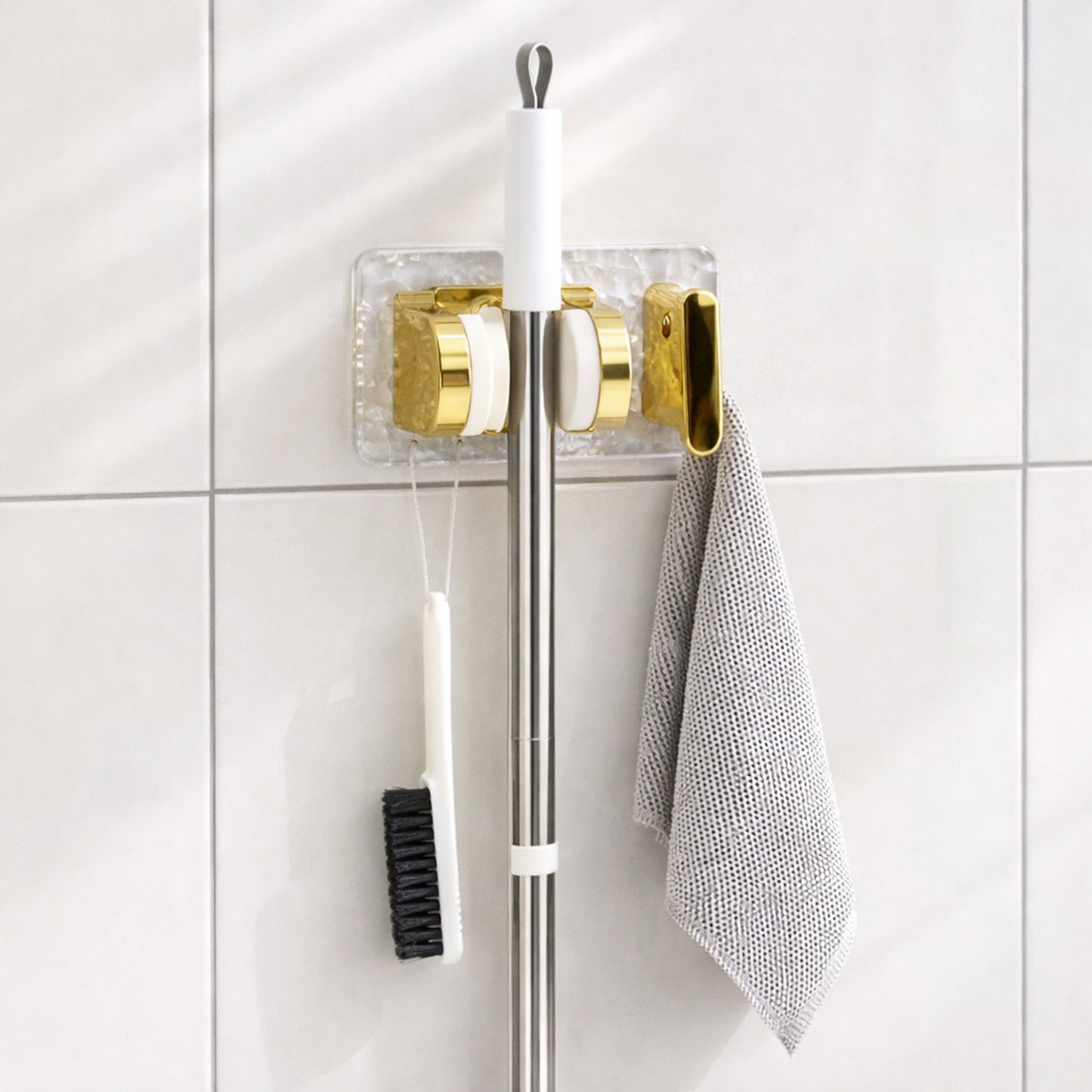 Space saving broom and mop hanger