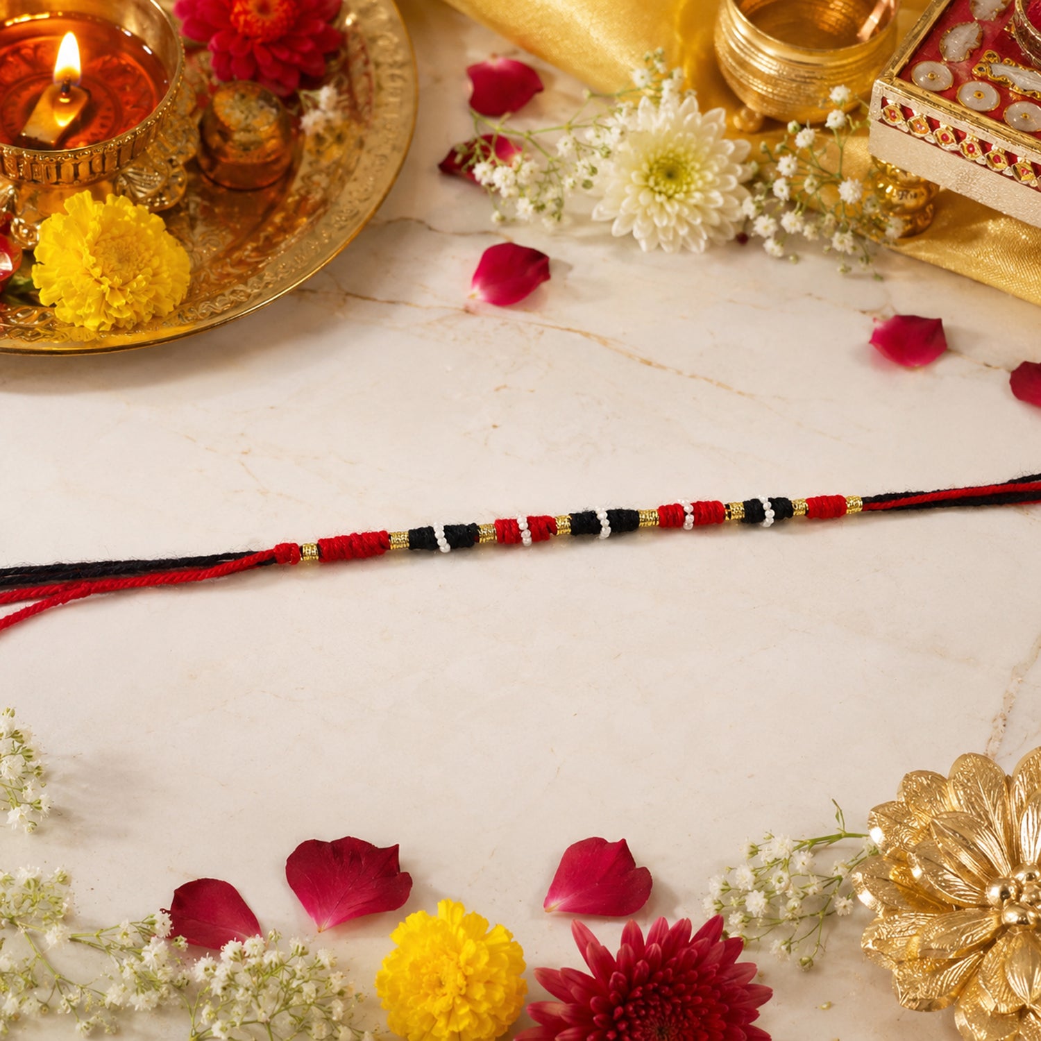 Close-up of Red Black Thread Rakhi Handmade Design