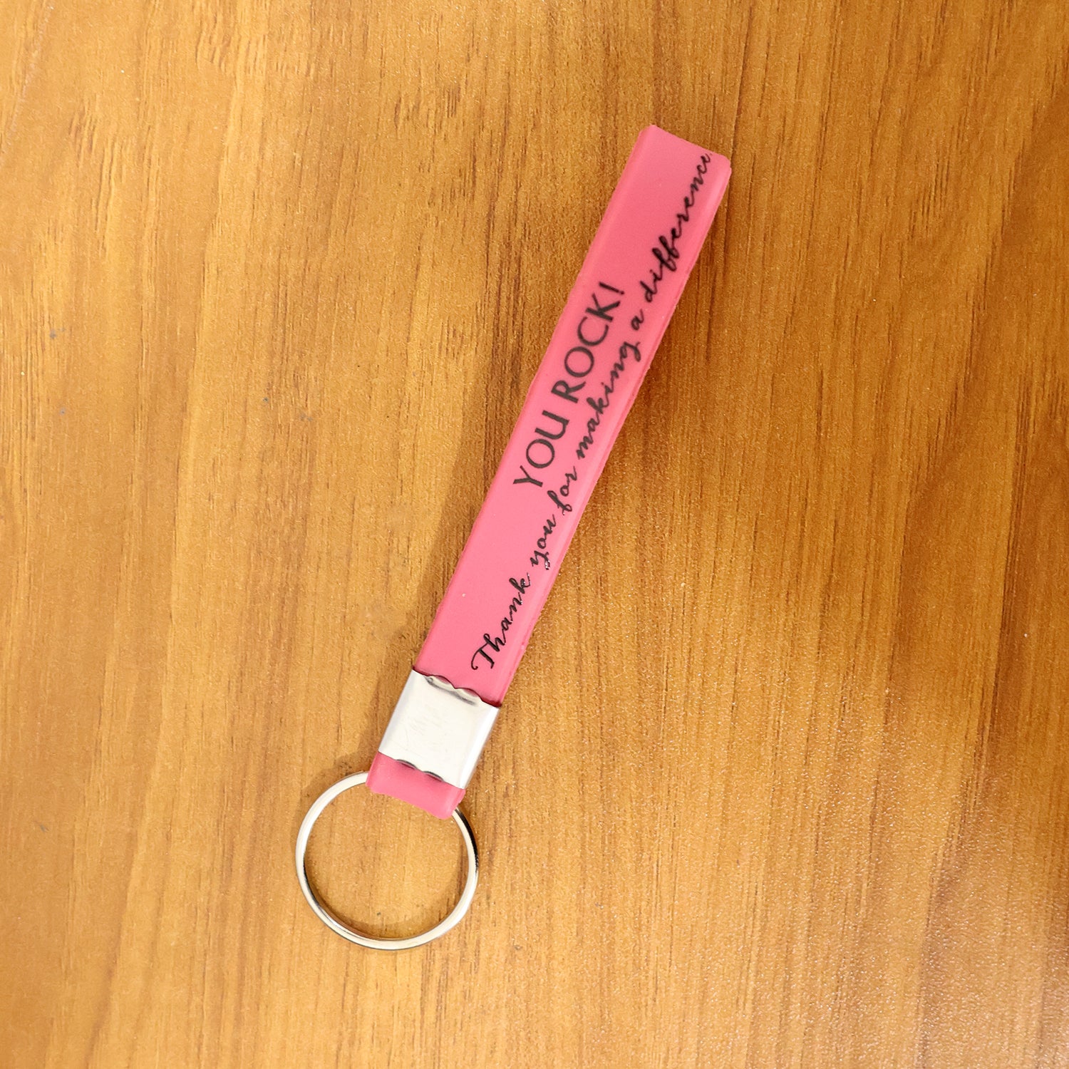 Silicone wrist strap keychain on a table