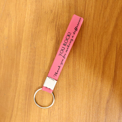 Silicone wrist strap keychain on a table