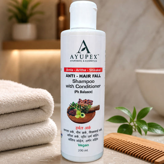 White bottle of AyupeX Anti-Hair Fall Shampoo with Conditioner, 200ml, on a bathroom counter with towels and a comb.