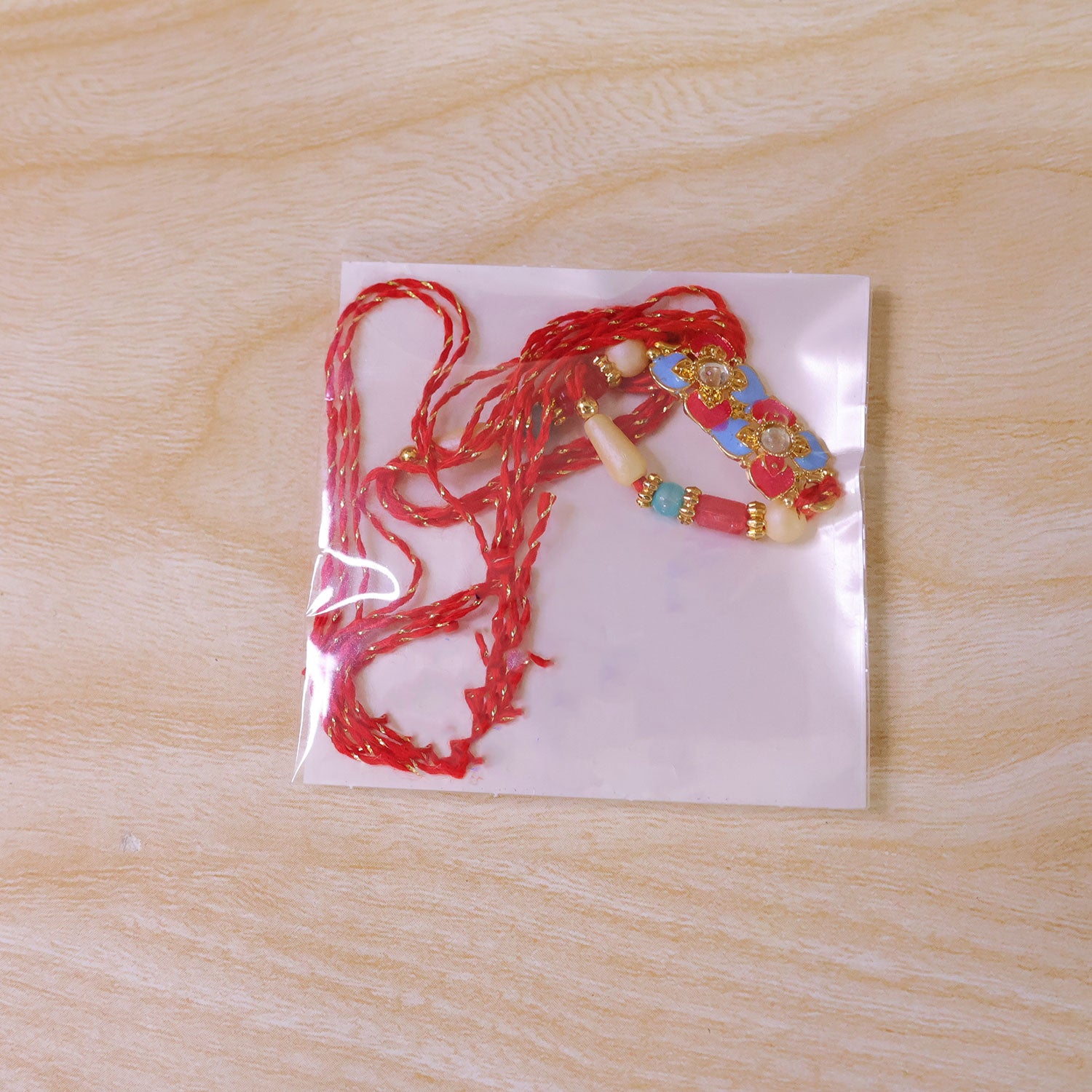 Multicolor Floral Kundan Pendant Rakhi with Red and Blue Beads
