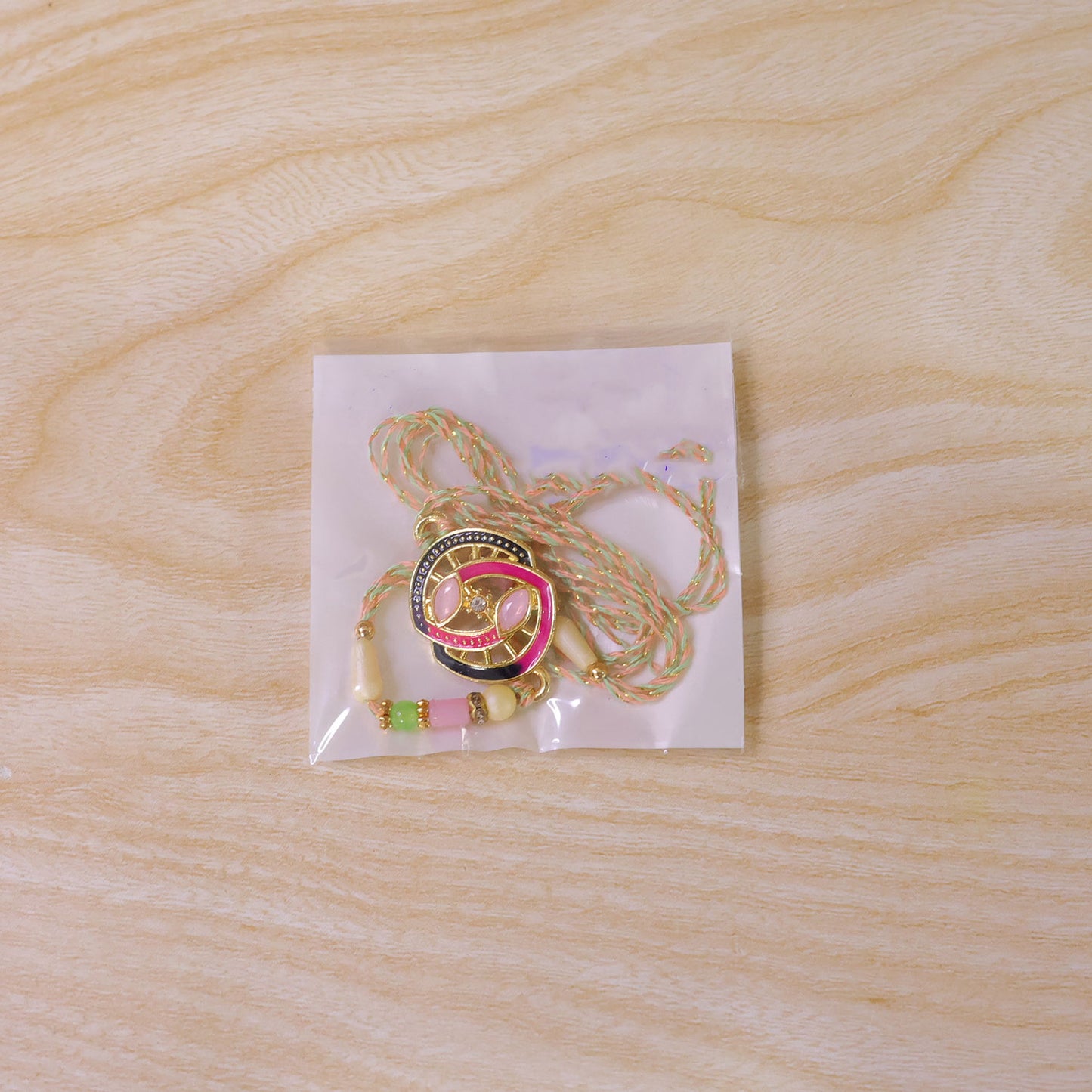 Black and Pink Enamel Spiral Pendant Rakhi with Pastel Beads