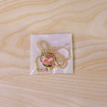 Black and Pink Enamel Spiral Pendant Rakhi with Pastel Beads