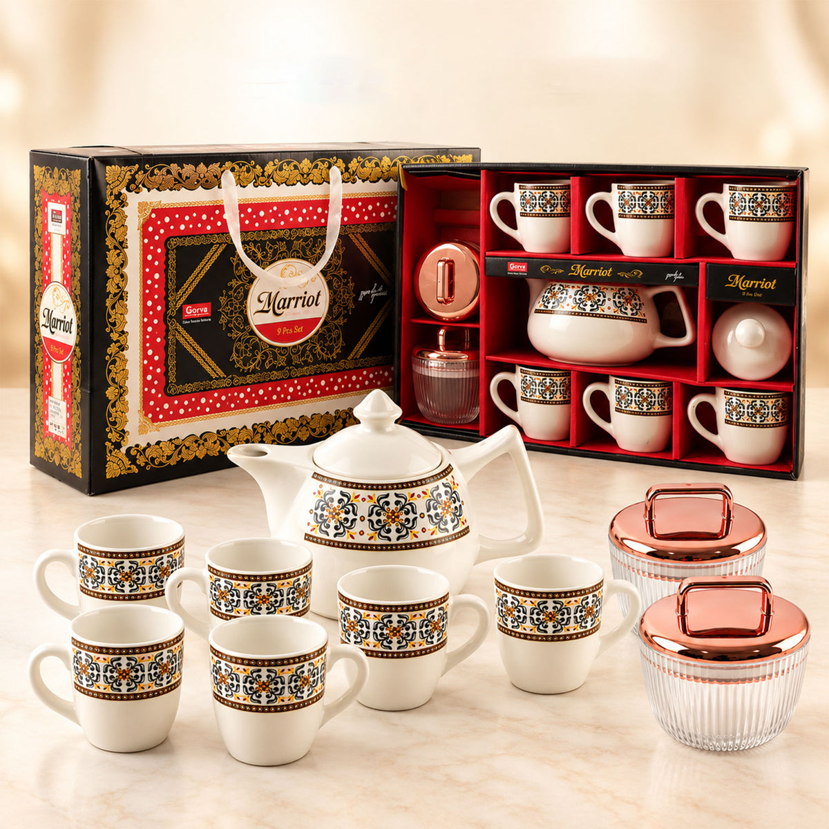A Marriot gift box, open to reveal a tea set, sits behind the full ceramic teapot, six cups, and two jars.