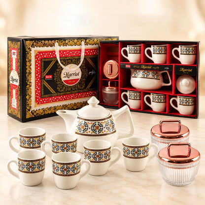 A Marriot gift box, open to reveal a tea set, sits behind the full ceramic teapot, six cups, and two jars.
