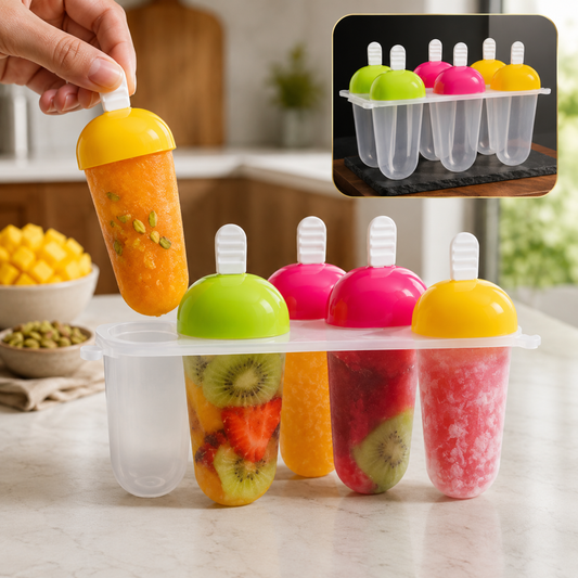 A hand holds an orange popsicle from a 6-piece mold with other fruit-filled popsicles, on a kitchen counter