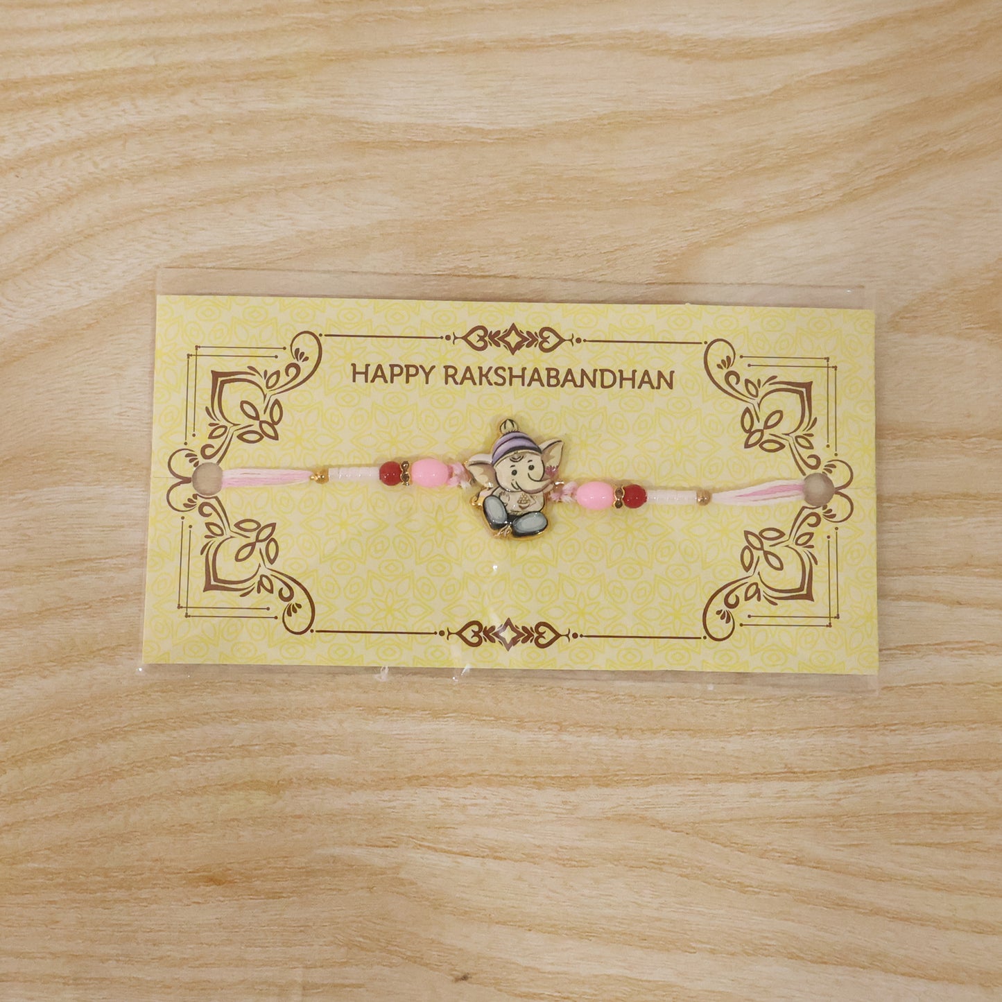 Cute Ganesha Designer Rakhi with Pink and Red Beads (1 Pc)