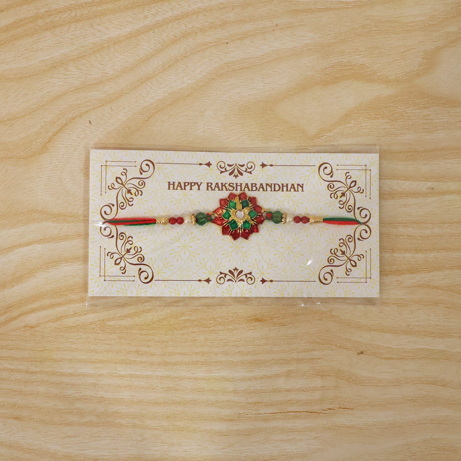 Elaborate Layered Lotus Rakhi Embellished in Red-Green Enamel and a Crystal Core
