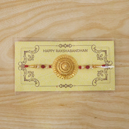 Decorative gold Rakhi ideal for traditional Raksha Bandhan rituals