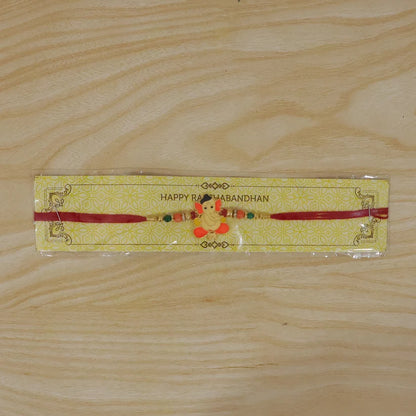 Bal Ganesha Rakhi – Vibrant Orange-Green Beads & Red Thread