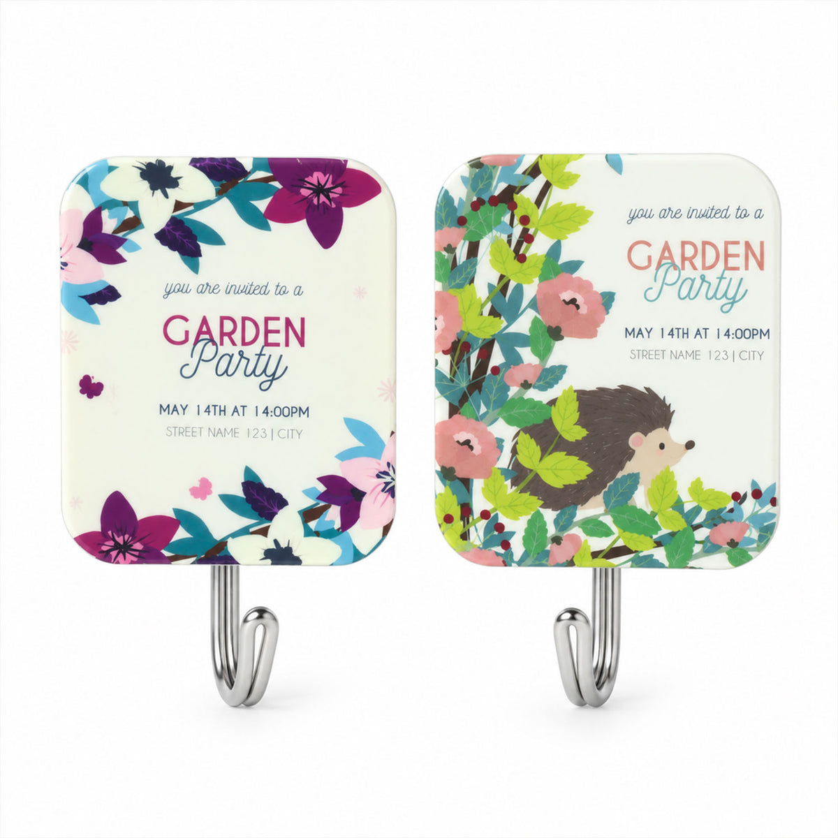 A pair of white rectangular sticky hooks, one with purple flowers, the other with a hedgehog and pink blossoms.