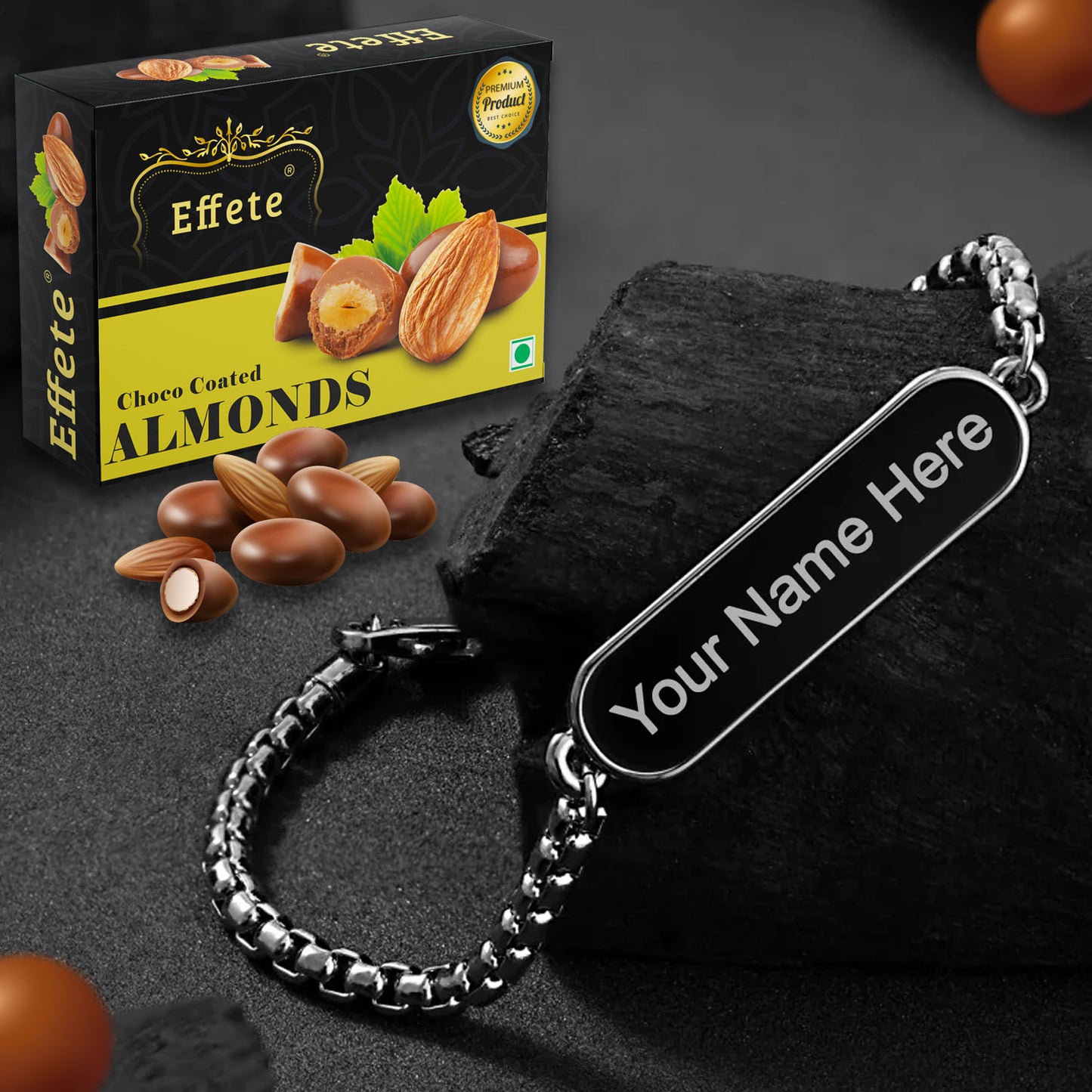 Close-up of a personalized silver bracelet next to a box of gourmet chocolates, ready as a thoughtful gift.