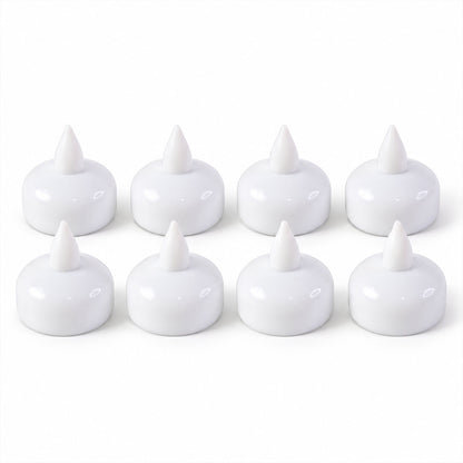 Eight white, unlit floating LED diyas are neatly arranged in two rows on a plain white surface.