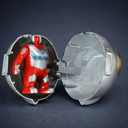 Multiple superhero capsule toys displayed as collectibles