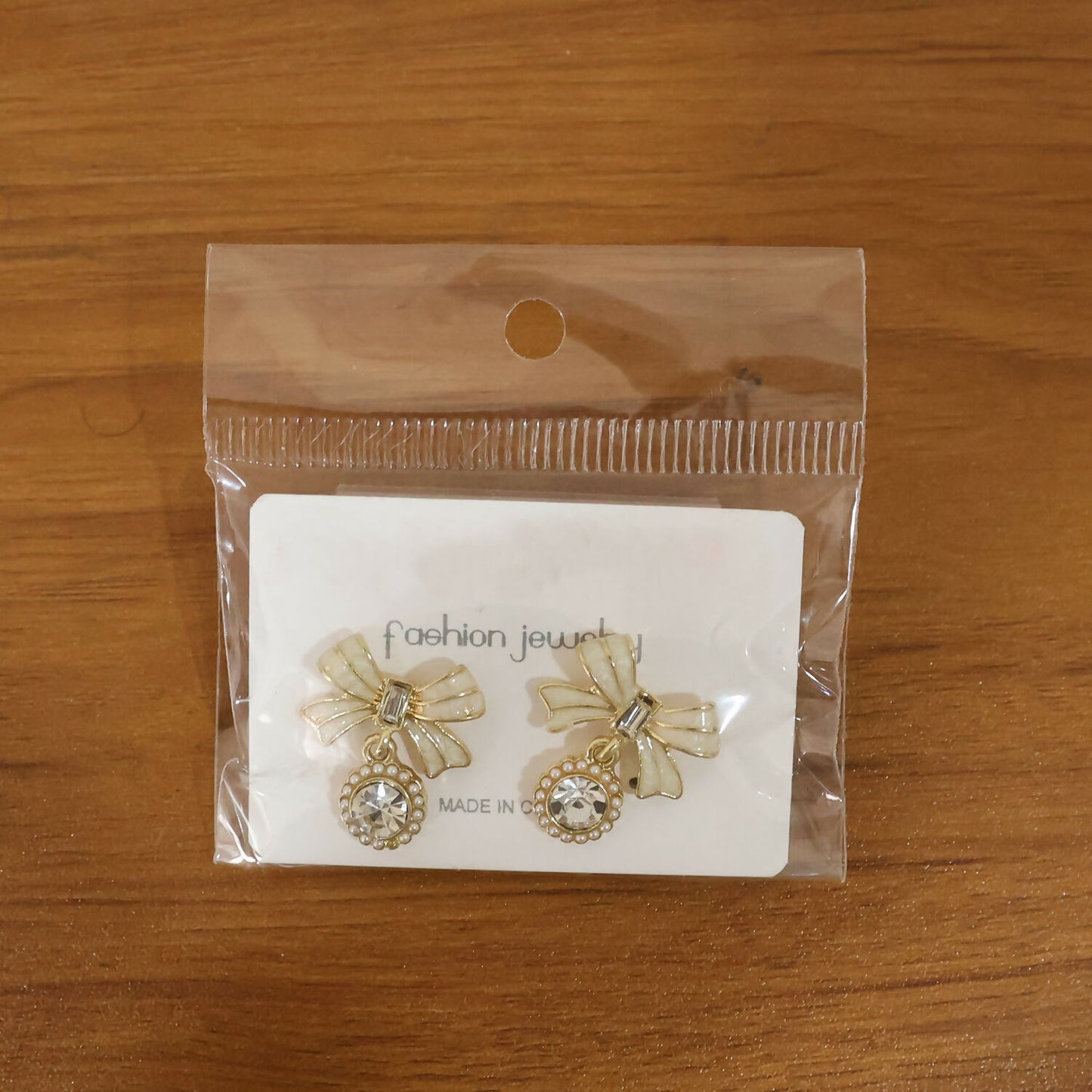 Crystal bow drop earrings worn showcasing sparkling design