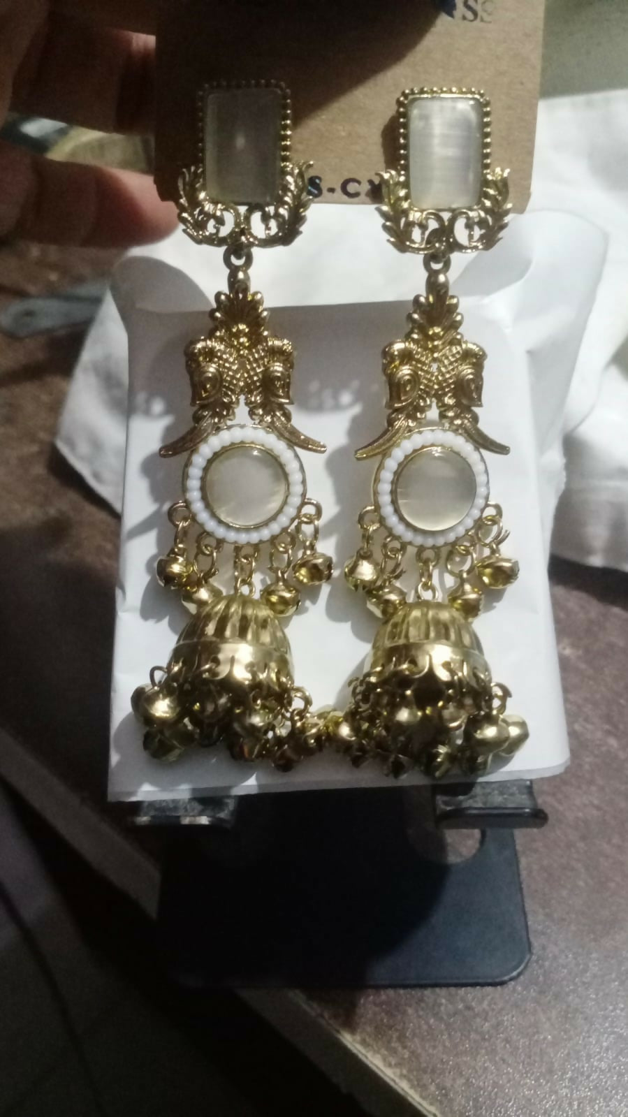 Styled photo of Kashmiri pearl and stone jhumka earrings worn with ethnic outfit