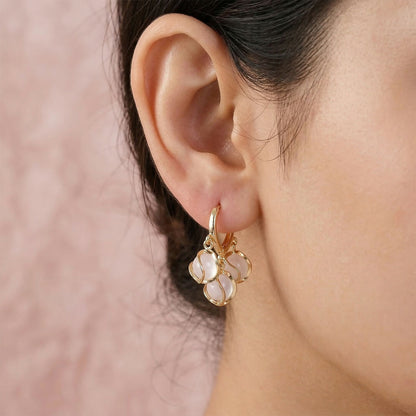 Side view of opal cluster hoop earrings