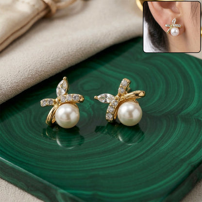Pearl butterfly stud earrings close-up on white background