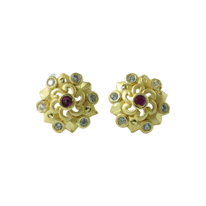 Detailed view of floral gold earrings with shimmering stones