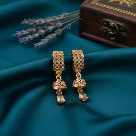Close-up of elegant Jhumka style teardrop earrings with gold-tone crystal studs