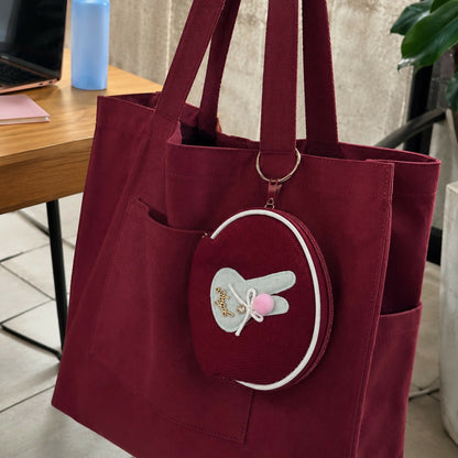 Front view of bunny coin pouch showing zipper and keyring